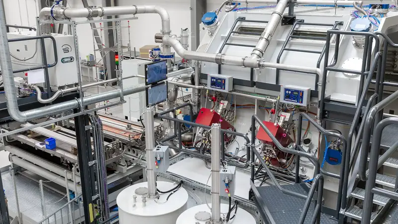 Perspective view of a VON ARDENNE FOBA roll-to-roll web coating system.