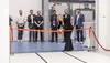 The photo depicts the managing director slicing the red ribbon during the opening of the cleanroom at VON ARDENNE.